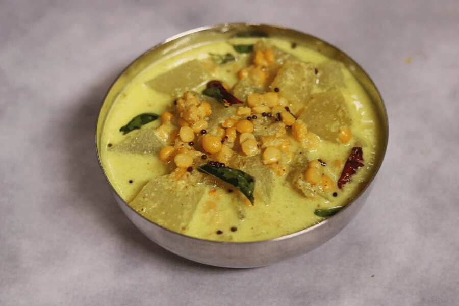 Vellai Poosanikai Kootu is a gluten-free, vegan Ash Gourd (Petha) and Split Bengal Gram (Chana Dal) cooked in a coconut paste.