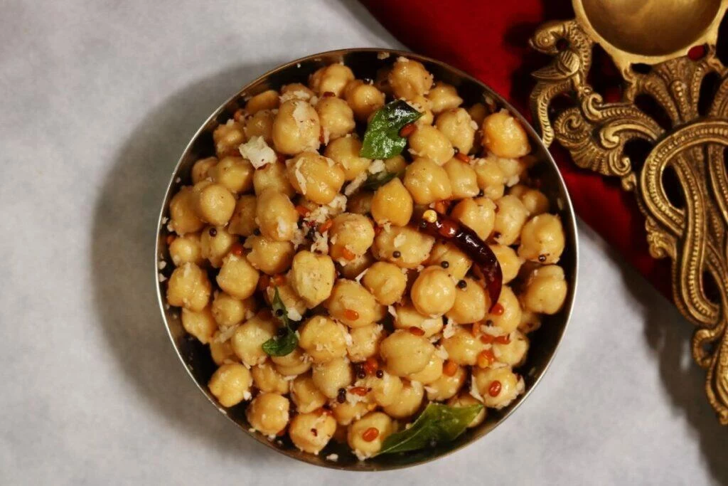 A bowl of Guggillu or Sundal, a protein-rich, vegan snack of boiled chickpeas flavoured with grated coconut.