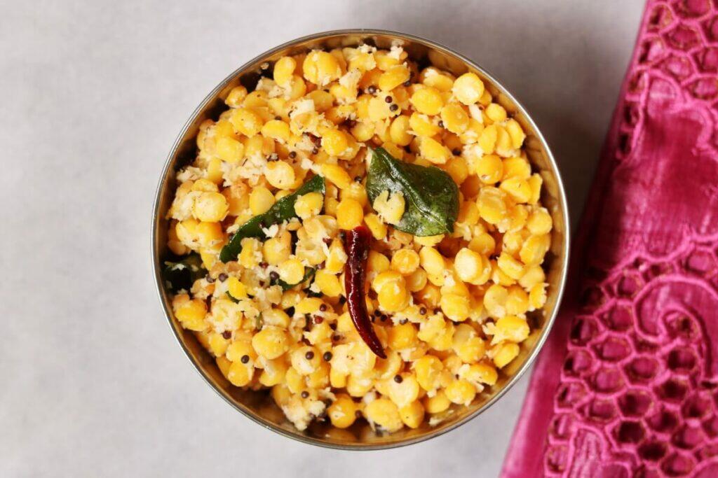 A bowl of Kadalai Paruppu Sundal, a vegan snack of boiled and tempered chana dal seasoned with grated coconut