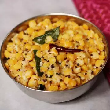 A bowl of Senaga Pappu Kobbari Kura or Kadalai Paruppu Sundal, a vegan snack rich in plant-based protein.