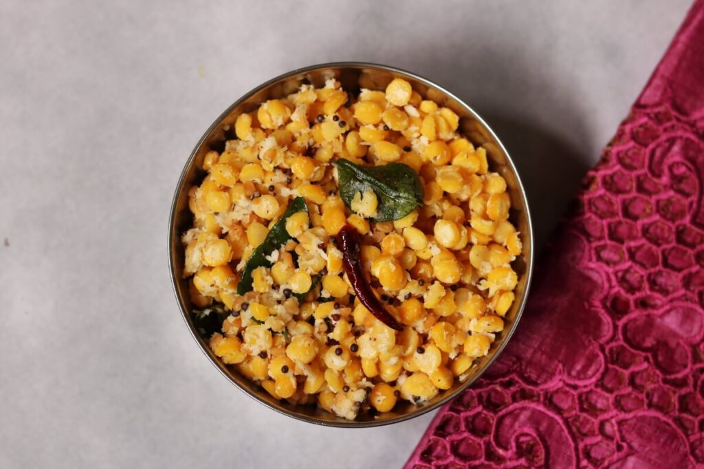 A bowl of Andhra Senaga Pappu Kobbari Kura (Chana Dal and Coconut stir-fry) that is eaten with rice and ghee
