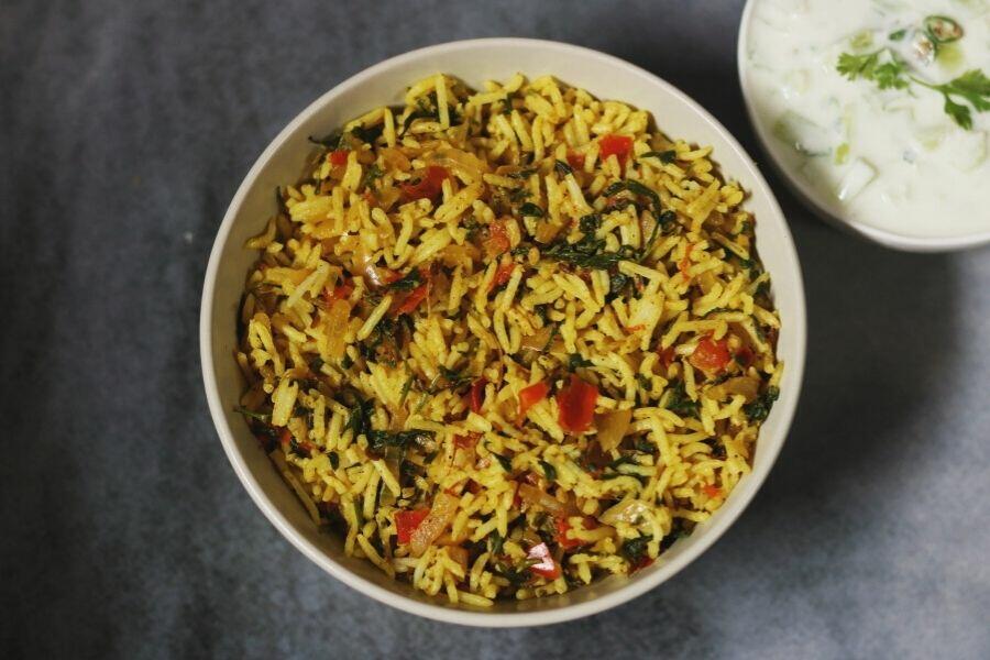 Tomato Methi Rice served with cucumber raita