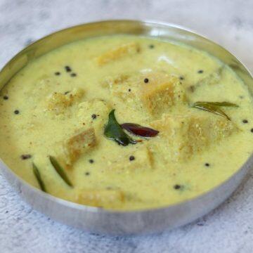 Kalan, a traditional Kerala dish of Banana & Yam in a coconut and yogurt gravy flavoured with pepper and fenugreek.