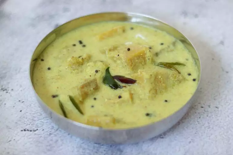 Kalan, a traditional Kerala dish of Banana & Yam in a coconut and yogurt gravy flavoured with pepper and fenugreek.