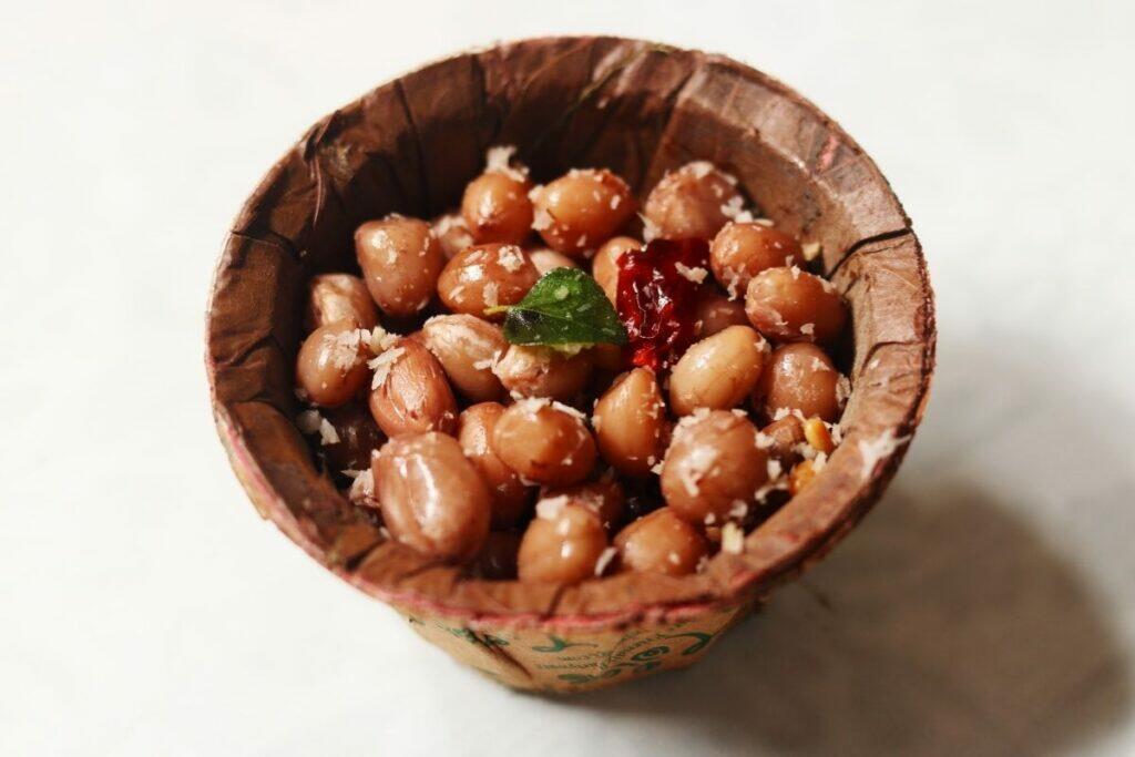 Palli Guggillu or Verusenaga Guggillu (boiled peanuts with coconut and tempering) served in a leaf bowl.