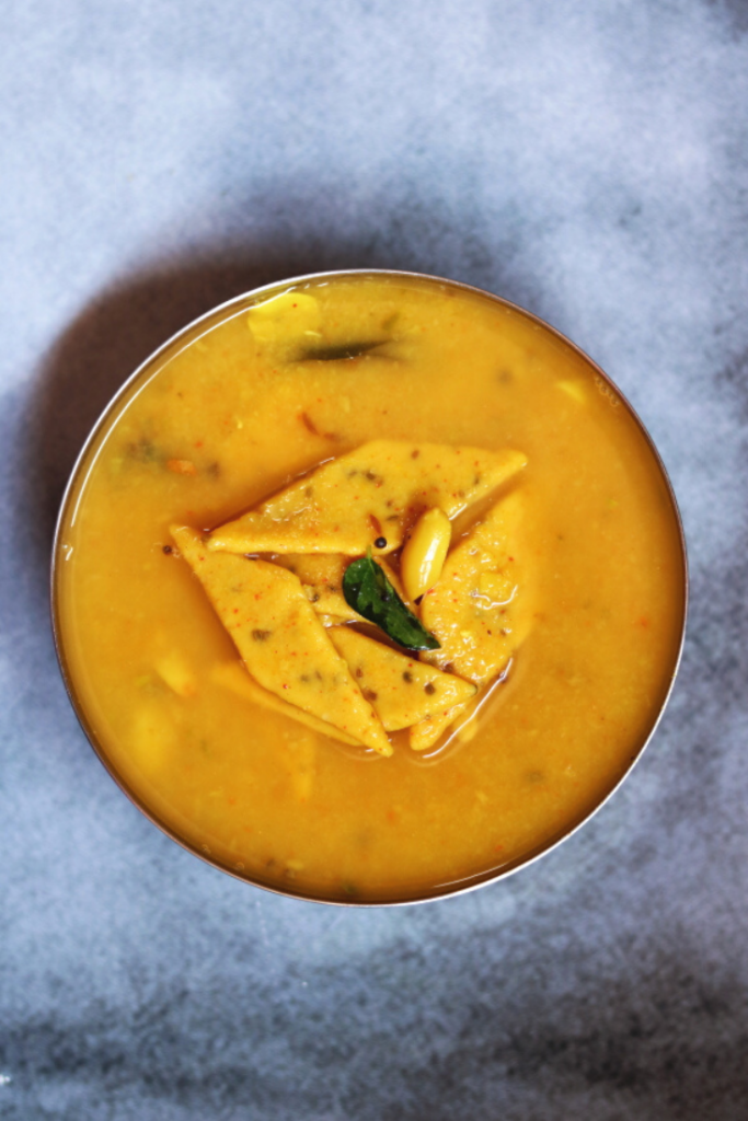 Gujarati Dal Dhokli: Think, small pieces of spiced wheat flour cooked in a sweet and tangy dal