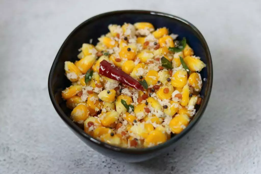 Sweet Corn Sundal made with boiled corn kernels garnished with grated coconut