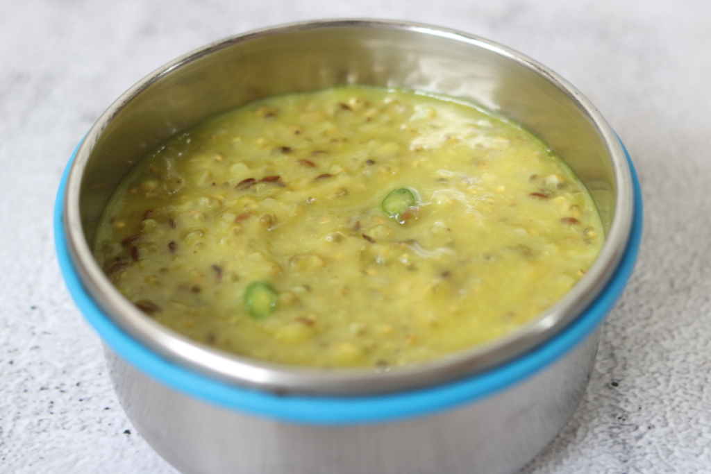 Bajra Khichdi, or Bajrichi Khichdi in Marathi, is a winter dish of moong dal and bajra tempered with ghee, cumin seeds, and green chillies.