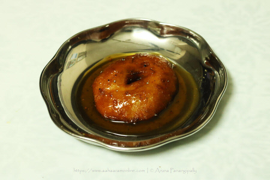 Bellam Garelu or Medu Vada soaked in Jaggery Syrup