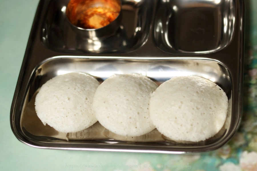 Rice and Poha Idli is a soft and fluffy steamed dumpling made with a fermented batter of rice and rice flakes (beaten rice).