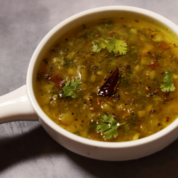 Mamidikaya Pachi Pulusu is an Andhra Cold Raw Mango Onion Rasam that is eaten with rice