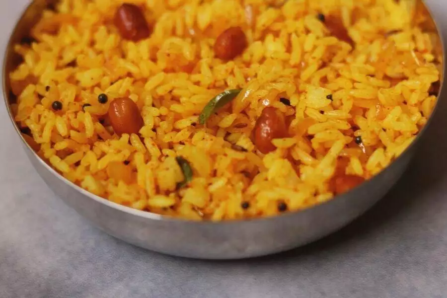 A close up of a bowl of Phodnicha Bhat, the Maharashtrian Seasoned Rice