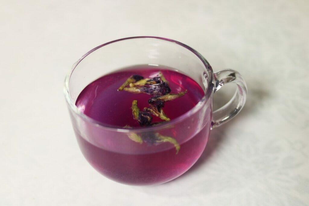 Shankhapushpi Herbal Tea or Butterfly Pea Flower Tisane turns a lovely purple when Lemon juice is added  to it.