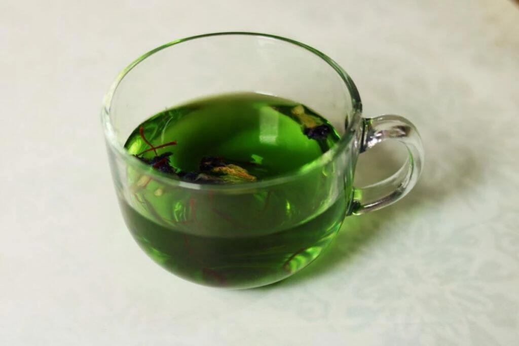Butterfly Pea Flower Tisane or Shankhapushpi Herbal Tea turns a brilliant green when you add Saffron.