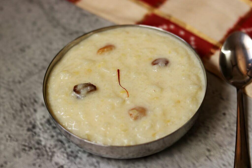 A bowl of Kalkandu Pongal, a creamy and luscious dessert made with rice, moong dal, milk, and rock sugar (sugar candy)