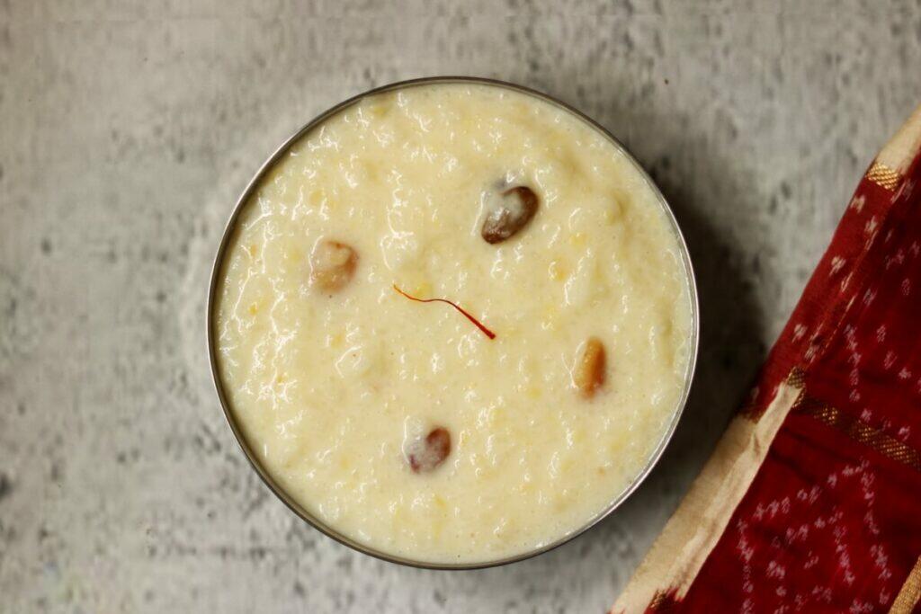 A bowl of creamy and luscious Kalkandu Sadam or Kalkandu Pongal, a dessert made with rice, moong dal, milk, and rock sugar (sugar candy)
