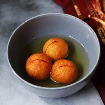 A bowl of spongy and delicious Suji ke Gulab Jamun for the festive season