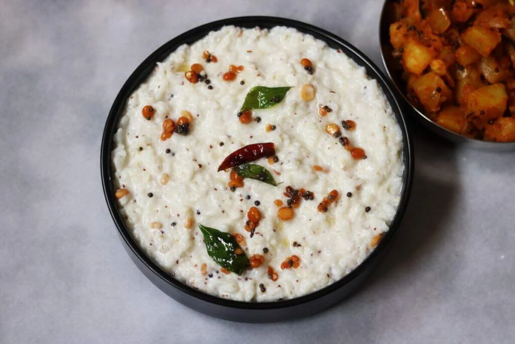A bowl of curd rice flavoured with mustard, called Ava Pettina Daddojanam in Andhra Pradesh and Telangana