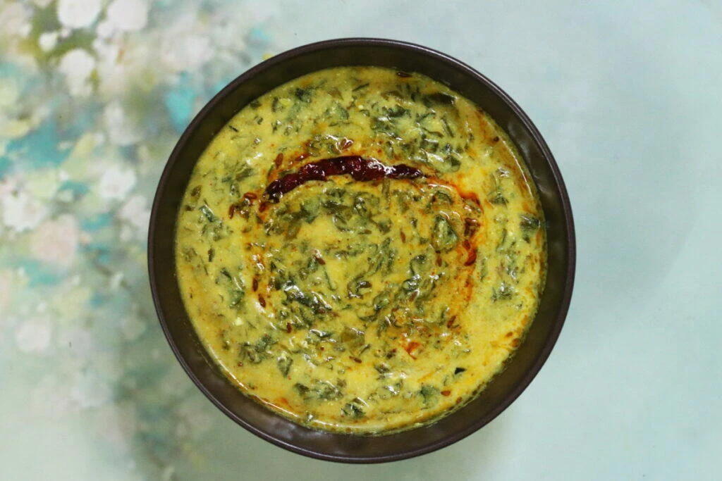 Methi Kadhi is a traditional Punjabi dish of fresh fenugreek leaves cooked in a spiced yogurt base.