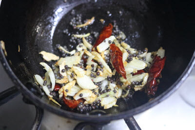Tempering of crushed garlic, mustard seeds, and dried red chillies