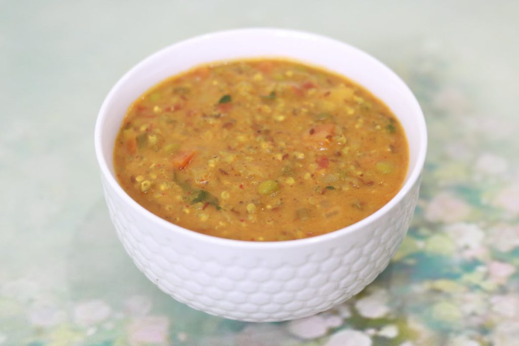 Masala Bajra Khichdi, a delicious, moderately-spiced one-dish meal made with pearl millet, moong dal, and vegetables. 