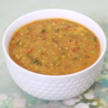 Masala Bajra Khichdi, a delicious, moderately-spiced one-dish meal made with pearl millet, moong dal, and vegetables.