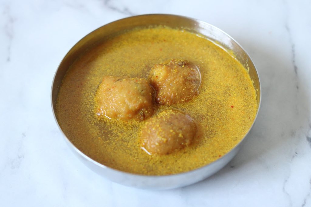 Rajasthani Kanji Vada consisting of fermented, probiotic rich mustard-flavoured water and moong dal vadas.