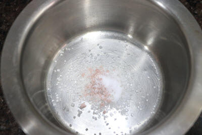 Add sugar, Sendha Namak and regular salt to a bowl. 