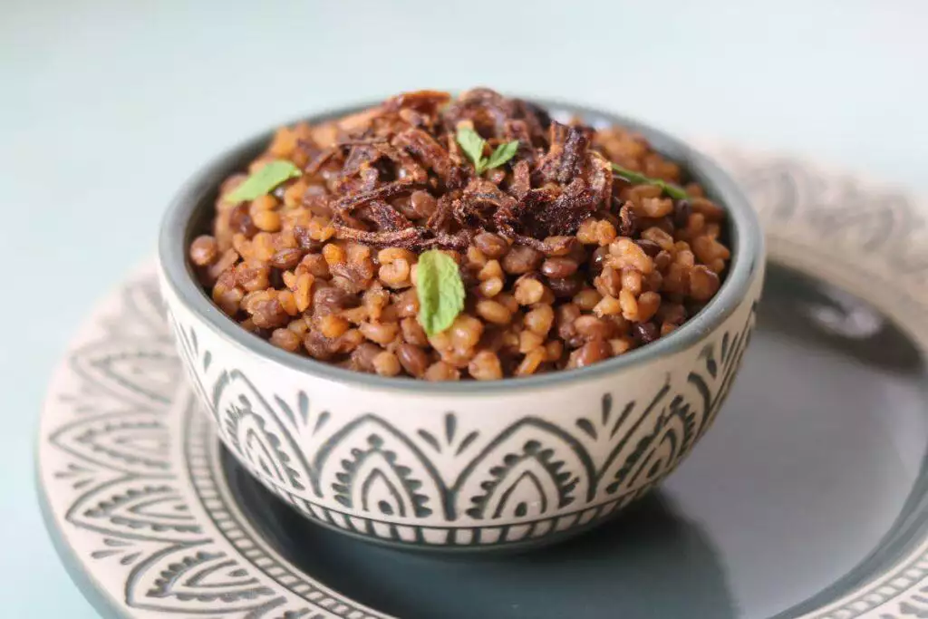 Mujadara, the vegan middle-eastern pilaf made with whole brown or green lentils, caramalized onions, and bulgur (or rice) 