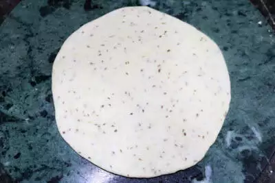 The dough rolled to a thick disc.